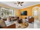 Cozy living room with modern furniture, a ceiling fan, and access to a screened-in outdoor area at 507 Westwind Dr, Davenport, FL 33896