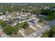 Aerial shot showcasing a residential area surrounded by lush trees and a nearby lake at 528 Courtland Blvd, Deltona, FL 32738