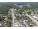 Wide aerial perspective of a town with scattered homes, trees, and a long road at 528 Courtland Blvd, Deltona, FL 32738
