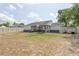 Expansive backyard features a lawn, patio, white fence, and treed perimeter for privacy at 528 Courtland Blvd, Deltona, FL 32738