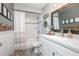 Bathroom featuring a shower-tub combo, modern vanity, and a decorative mirror providing a spa-like experience at 528 Courtland Blvd, Deltona, FL 32738