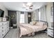 Bedroom with a modern ceiling fan, stylish decor, a decorative rug, and plush pillows atop a black metal bed frame at 528 Courtland Blvd, Deltona, FL 32738