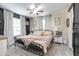 Cozy bedroom with a metal bed frame, ceiling fan, natural light, and stylish decor at 528 Courtland Blvd, Deltona, FL 32738