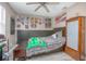 Bedroom featuring decor, ceiling fan, gray wood-look flooring, and a vintage-style storage cabinet at 528 Courtland Blvd, Deltona, FL 32738