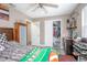 Bedroom with a mounted ceiling fan, gray flooring, walk-in closet, and plenty of storage in wooden cabinet at 528 Courtland Blvd, Deltona, FL 32738