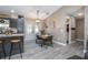 Dining area features a wooden table set adjacent to an island with dark wood cabinets at 528 Courtland Blvd, Deltona, FL 32738