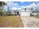 Charming single-Gathering home featuring two-tone paint scheme, an attached garage and landscaping at 528 Courtland Blvd, Deltona, FL 32738