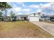 Charming single-Gathering home featuring two-tone paint scheme, an attached garage and landscaping at 528 Courtland Blvd, Deltona, FL 32738