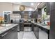 Sleek kitchen featuring stainless steel appliances and dark cabinetry with granite countertops at 528 Courtland Blvd, Deltona, FL 32738