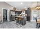 Well-lit kitchen features stainless appliances, island with breakfast bar, and dark wood cabinets at 528 Courtland Blvd, Deltona, FL 32738