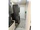 Functional laundry room featuring a stacked washer and dryer unit with tiled floors at 528 Courtland Blvd, Deltona, FL 32738