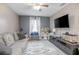 Bright living room with a ceiling fan, flat screen television, comfortable sofa and decorative rug at 528 Courtland Blvd, Deltona, FL 32738