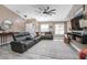 Comfortable living room with gray, leather sectional, ceiling fan, and stylish decor at 528 Courtland Blvd, Deltona, FL 32738