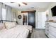 Bedroom with metal bed, barn door to bathroom, and a full dresser at 528 Courtland Blvd, Deltona, FL 32738