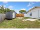 A backyard with a shed, grass, stepping stones, and a wooden fence at 5338 Tangerine Ave, Winter Park, FL 32792