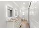 Hall bathroom featuring double sink vanity with granite counter and modern lighting at 5338 Tangerine Ave, Winter Park, FL 32792