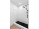 Modern stand up shower features black tile floor and black rainfall shower head at 5338 Tangerine Ave, Winter Park, FL 32792