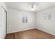 Well-lit bedroom featuring hardwood floors, white walls, and a closet for ample storage space at 5338 Tangerine Ave, Winter Park, FL 32792