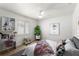 Bright bedroom with white walls, ceiling fan, and decor with a charming and cozy ambiance at 5338 Tangerine Ave, Winter Park, FL 32792