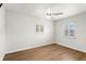 Bright bedroom with hardwood floors, white walls, and shuttered windows, providing a blank canvas at 5338 Tangerine Ave, Winter Park, FL 32792