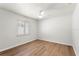 Clean, empty bedroom with hardwood floors and white walls, awaiting personal touches at 5338 Tangerine Ave, Winter Park, FL 32792