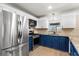 Bright modern kitchen featuring stainless steel appliances, granite countertops, and updated cabinets at 5338 Tangerine Ave, Winter Park, FL 32792