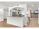 Open kitchen featuring granite counters, stainless appliances, and an eat-in breakfast bar at 5338 Tangerine Ave, Winter Park, FL 32792