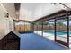 Enclosed patio area with blue flooring, pool views, and a cozy ambiance for outdoor relaxation at 5338 Tangerine Ave, Winter Park, FL 32792