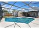A screened in pool with a stone deck, outdoor lights, and the house in the background at 5338 Tangerine Ave, Winter Park, FL 32792