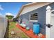 Side yard featuring a painted brick wall, equipment, and gravel at 5338 Tangerine Ave, Winter Park, FL 32792
