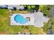 Aerial view of the community pool and clubhouse, with lush landscaping, lounge chairs, and outdoor amenities at 5395 Dover Village Ln # 305, Orlando, FL 32812