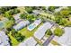 Aerial view of the community highlighting the pool, buildings, parking, and green spaces in the neighborhood at 5395 Dover Village Ln # 305, Orlando, FL 32812