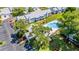Aerial view of the community pool, showcasing the buildings, sun deck, and surrounding green spaces at 5395 Dover Village Ln # 305, Orlando, FL 32812