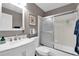 Clean bathroom with bright vanity, mirrored medicine cabinet, and glass door shower/tub combo at 5395 Dover Village Ln # 305, Orlando, FL 32812