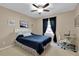 Bright bedroom featuring ceiling fan, large window with curtains and a dedicated desk for work or study at 5395 Dover Village Ln # 305, Orlando, FL 32812