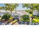 Exterior view of the community clubhouse, featuring well-maintained landscaping and accessible parking at 5395 Dover Village Ln # 305, Orlando, FL 32812