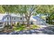 Charming exterior of a condo with an attached garage, surrounded by a well-maintained lawn and mature trees at 5395 Dover Village Ln # 305, Orlando, FL 32812