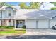 Charming light blue townhome with a two-car garage and well-maintained front lawn at 5395 Dover Village Ln # 305, Orlando, FL 32812