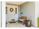 Inviting front porch featuring a decorative wreath, bench, and potted plant accents at 5395 Dover Village Ln # 305, Orlando, FL 32812