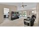 Bright living room with a large television, comfortable seating, and access to the kitchen at 5395 Dover Village Ln # 305, Orlando, FL 32812
