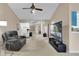 Bright living room featuring a large television and comfortable seating at 5395 Dover Village Ln # 305, Orlando, FL 32812
