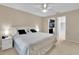 Bright main bedroom with neutral walls, white ceiling fan, and ensuite bathroom access at 5395 Dover Village Ln # 305, Orlando, FL 32812