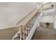 Carpeted staircase with wood railing leads to the upper level of the home at 5395 Dover Village Ln # 305, Orlando, FL 32812