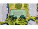 Aerial view of the community tennis courts, bordered by trees and lush landscaping at 5395 Dover Village Ln # 305, Orlando, FL 32812