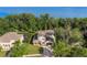 Stunning aerial view of the property with lush green surroundings, partial lake view, and a screened in pool at 557 Lake Cove Pointe Cir, Winter Garden, FL 34787