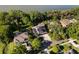 Large homes sit in a tree-lined neighborhood on the water at 557 Lake Cove Pointe Cir, Winter Garden, FL 34787