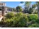 Landscaped backyard with patio area and lush flower beds offer privacy at 557 Lake Cove Pointe Cir, Winter Garden, FL 34787