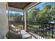 Relaxing balcony with seating and beautiful green views, ideal for enjoying the outdoors at 557 Lake Cove Pointe Cir, Winter Garden, FL 34787