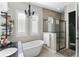 Elegant bathroom featuring a soaking tub, separate shower, and modern fixtures at 557 Lake Cove Pointe Cir, Winter Garden, FL 34787