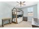 Charming bedroom featuring a stylish bunk bed and ample natural light from the window at 557 Lake Cove Pointe Cir, Winter Garden, FL 34787